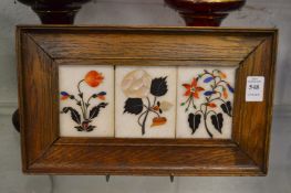 A set of three micromosaic panels in an oak frame.
