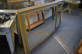 A pair of large modern wall mirrors with green and gilt decorated frames.