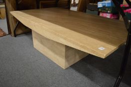 A large modern marble pedestal coffee table.