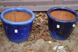 Two purple glazed plant pots.