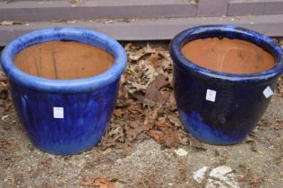 Two purple glazed plant pots.
