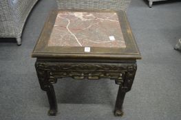 A Chinese carved wood square shaped urn stand with marble inset top.