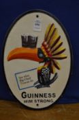 A novelty cast iron Guinness sign.