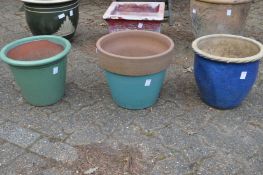 Three glazed garden pots.