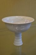 A Chinese blanc de chine stem cup with moulded decoration.