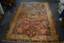 Persian design rug, pale red ground with all-over stylised decoration, 243cm x 156cm.