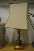 A brass table lamp.