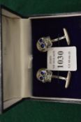 A pair of sterling silver skull shaped cufflinks.
