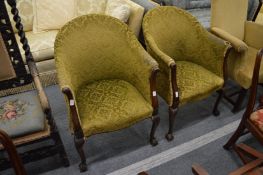 A pair of mahogany framed tub armchairs with carved cabriole legs.
