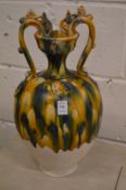A large Chinese twin handled vase with drip glazed decoration.