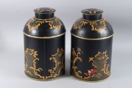 A PAIR OF CHINESE DESIGN TOLEWARE TEA JARS AND COVERS. 14ins high.