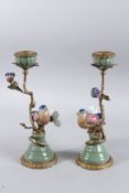 A PAIR OF PORCELAIN AND GILT METAL BIRDS AND FLOWERS CANDLESTICKS. 12ins high.