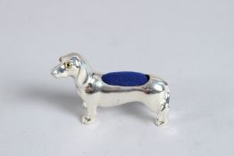 A SILVER DACHSUND DOG PIN CUSHION.