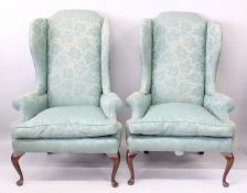 A PAIR OF HIGH BACK WING ARMCHAIRS.