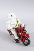 A CAST IRON MICHELIN MAN on a motor bike. 8.5ins high.