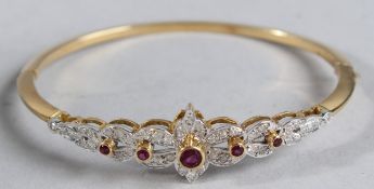 AN 18CT RUBY AND DIAMOND BANGLE.