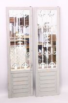 A PAIR OF PAINTED GARDEN MIRRORS.