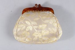 A SILK EVENING BAG with tortoiseshell clasp.