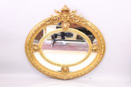A GOOD LOUIS XVITH STYLE OVAL GILTWOOD MIRROR with scrolls and shells. 3ft 9ins wide x 3ft 9ins