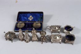 A BOX OF SILVER CONDIMENT SETS including a pair of shell salts, three mustard pots, two salts and