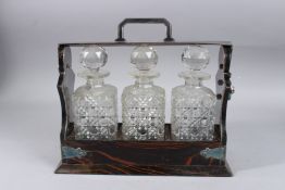 A THREE BOTTLE WHISKY TANTALUS BY ALEXANDER CLARK, FENCHURCH STREET. 13ins long.