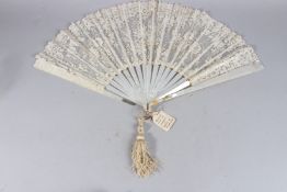 J. DUVELLEROY, LONDON. A BRUSSELS AND BOBBIN LACE AND NEEDLEPOINT FAN IN MOTHER-OF-PEARL, one stem