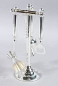 A SILVER PLATE SET OF BAR TOOLS.