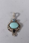 A SILVER TURQUOISE AND TOPAZ PENDANT.
