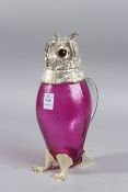 A GOOD SILVER PLATE AND CRANBERRY GLASS OWL CLARET JUG.