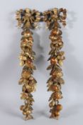 A PAIR OF 18TH CENTURY CARVED AND GILDED PANELS. 24ins longs, carved with ribbons, flowers and
