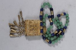 A JADE ISLAMIC NECKLACE AND GILT PENDANT.