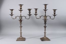A GOOD PAIR OF GEORGE IV SILVER THREE LIGHT CANDLESTICKS, 18ins high. London 1825. Maker: William