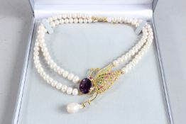 A SILVER AND GOLD PLATED, AMETHYST AND RUBY BUTTERFLY PEARL NECKLACE.