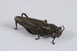AN ARTICULATED BRONZE LOCUST. 3.25ins long.