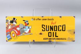 A SUNOCO OIL DISNEY ENAMEL SIGN. 9ins x 23ins.