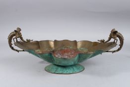 A COPPER AND ENAMEL OVAL SHAPED COMPORT with dragon handles. 17ins long.