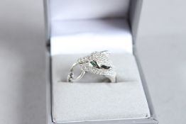 A SILVER PANTHER HEAD RING.
