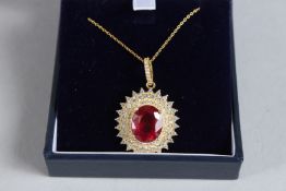 A SILVER AND GOLD PLATED RUBY CLUSTER PENDANT.
