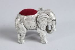 A LARGE SILVER PLATED ELEPHANT HAT PIN CUSHION.