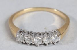 A DIAMOND FIVE STONE RING with 18ct white gold setting and yellow gold band.