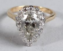 A LARGE PEAR SHAPED DIAMOND CLUSTER RING, 2.3ct centre stone surrounded by eight cut diamonds.