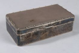 AN ENGINE TURNED SILVER CUGARETTE BOX. 6.25ins long. Birmingham 1955.
