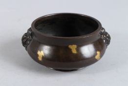 A CHINESE BRONZE GOLD SPLASH CENSER. 4ins diameter.