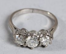 A THREE STONE DIAMOND RING in 18ct white gold.