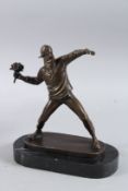 AFTER BANKSY. A BRONZE GROUP, A MAN THROWING A BUNCH OF FLOWERS. Signed.