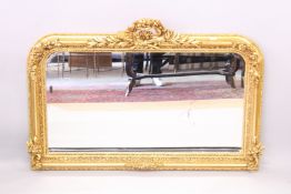 A GOOD LOUIS XVITH STYLE OVERMANTLE MIRROR with trumpets and scrolls. 4ft 3ins wide x 3ft 2ins