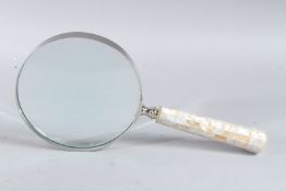A LARGE MOTHER-OF-PEARL HANDLED MAGNIFYING GLASS.