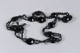 A LONG BLACK JET NECKLACE. 28ins long.