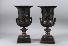 A GOOD PAIR OF CLASSICAL URN SHAPED TWO HANDLED BRONZE VASES on Blue John bases. 14ins high.