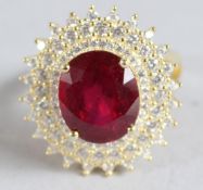 A SILVER AND GOLD PLATED RUBY CLUSTER RING.